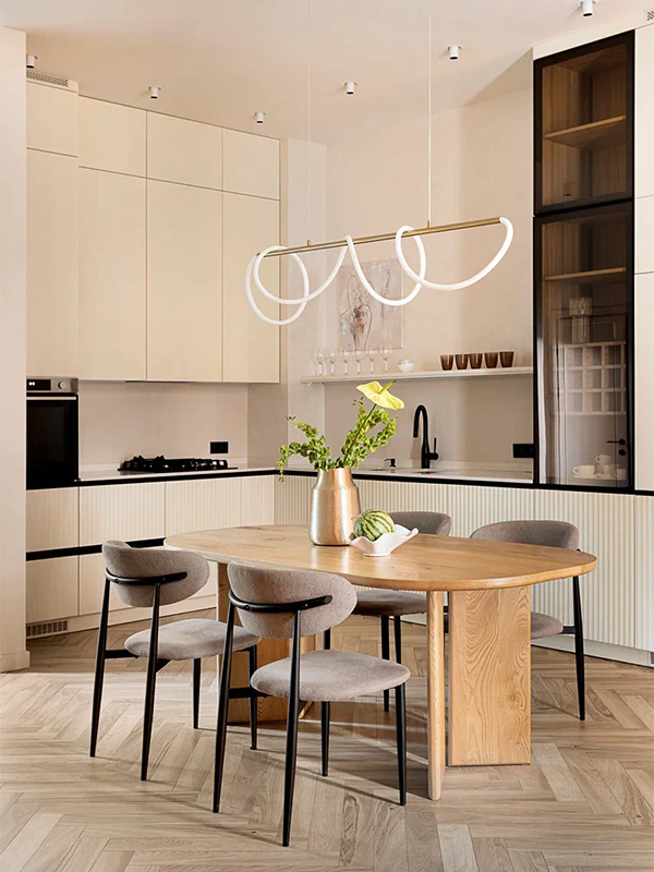 After: Arcus renovation at Habibi, kitchen with tall cream cabinets, oak table, loop pendant, herringbone floor