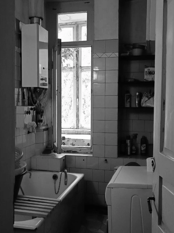 Old Tbilisi bathroom before renovation, with outdated tiles and compact layout