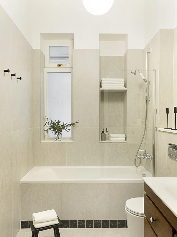 Completed modern bathroom with minimalist design, soft lighting, and full renovation by Arcus