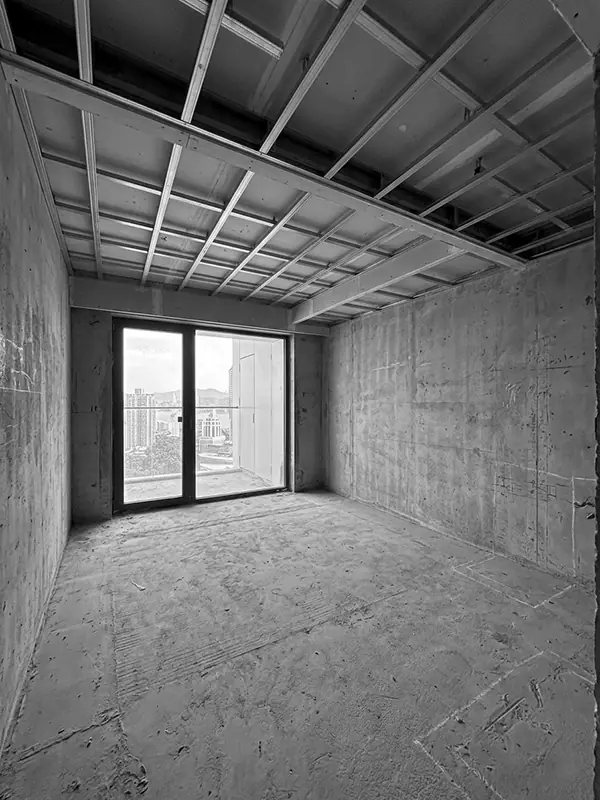 Studio apartment in Marriott residence in Batumi before renovation, raw concrete interior with metal ceiling frame and panoramic balcony doors