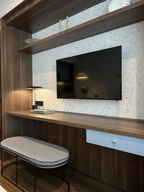 Finished studio apartment in Marriott residence in Batumi with custom TV wall, desk, shelving and upholstered bench