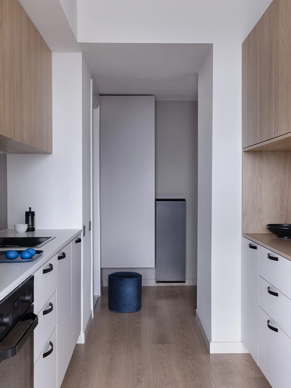 Bright modern kitchen with white cabinetry and wood accents, fully redesigned by Arcus