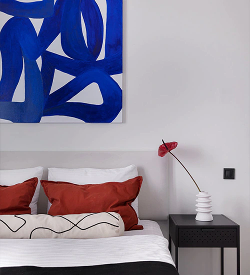 Minimal and vibrant bedroom in an Airbnb-ready apartment fully renovated by Arcus in Batumi