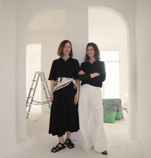 Founders of Arcus standing in a renovation project apartment during the early construction phase